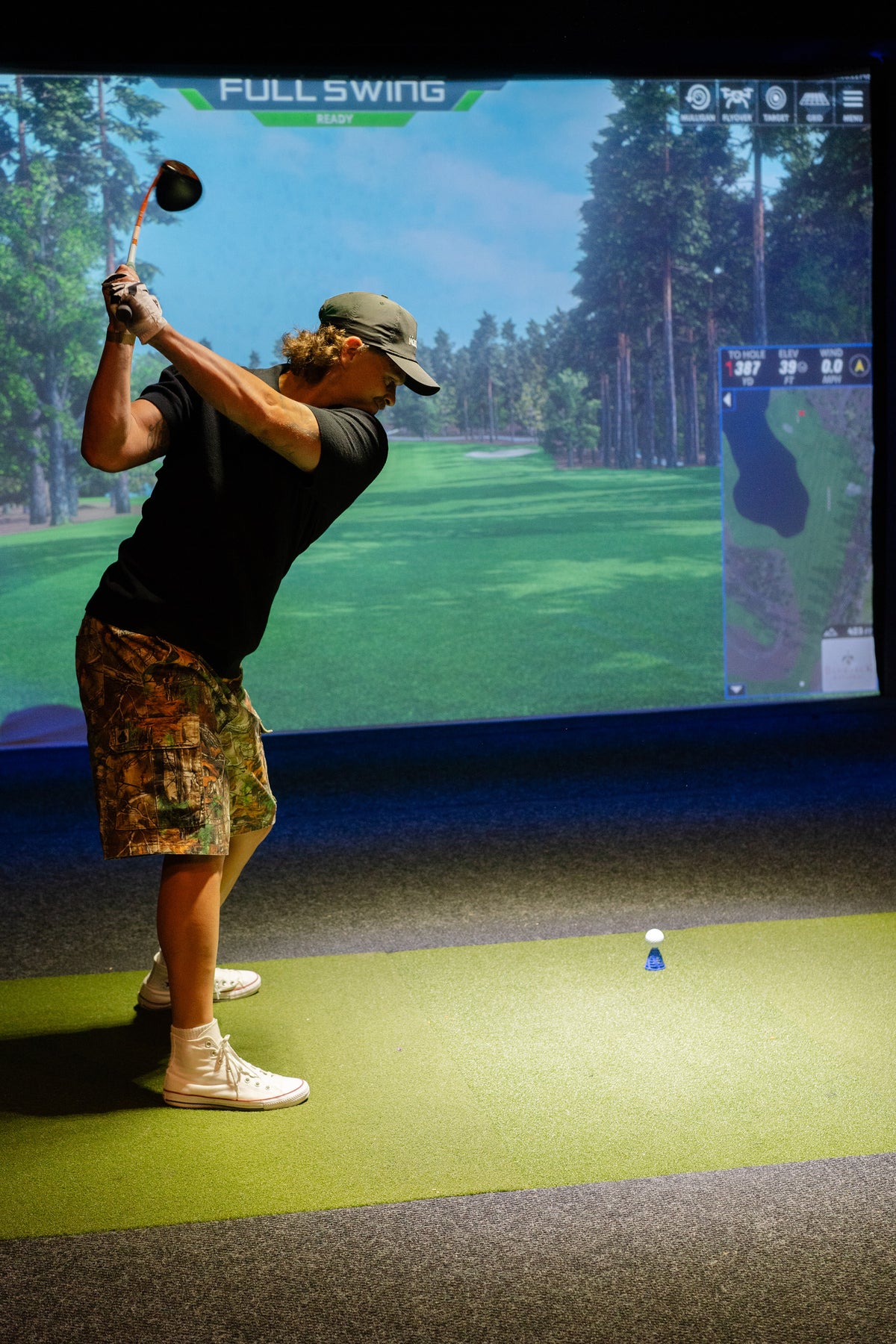 Golfer training in a Full Swing simulator at Parkwood Village